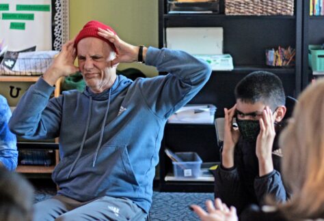 Joe and students practice putting on facial expressions